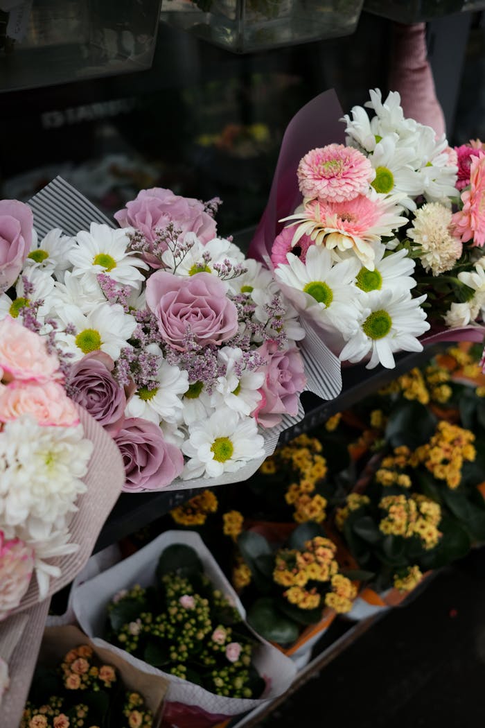 Captivating floral arrangements featuring pink roses and white daisies in a vibrant market setting.